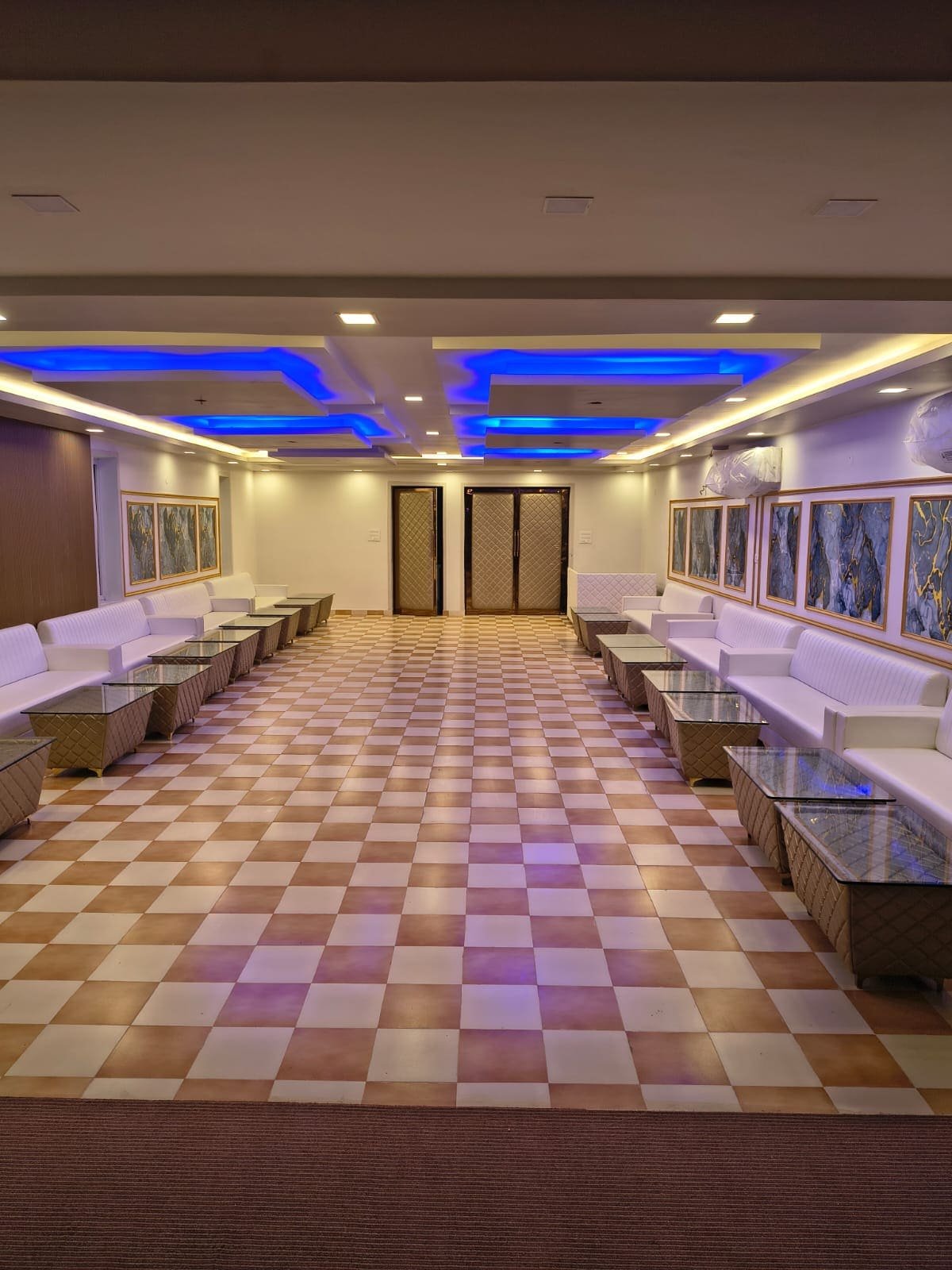 Rows of white sofa seating in the banquet hall