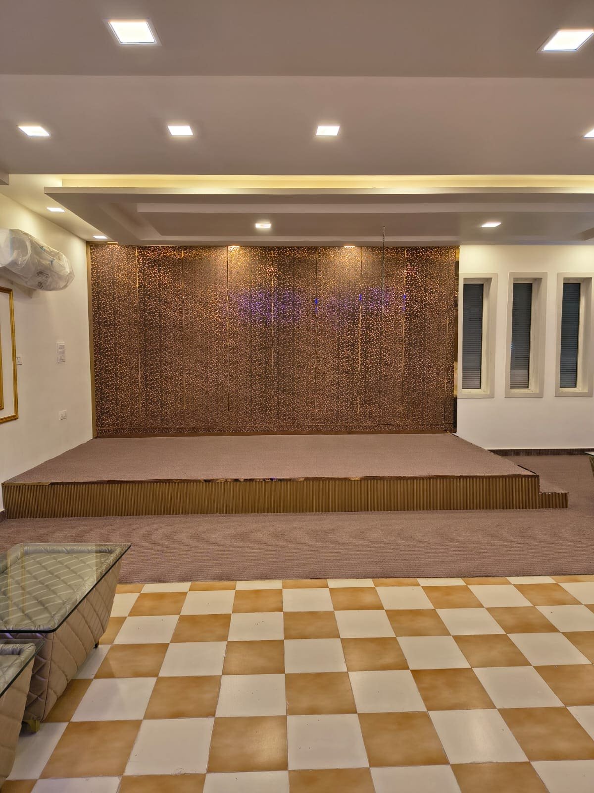 The banquet hall stage with a golden backdrop