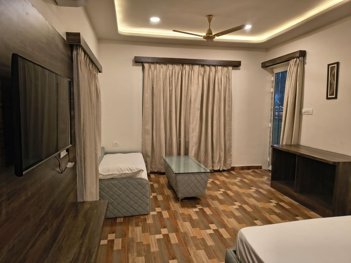 Guest room lounge corner with seating and a television